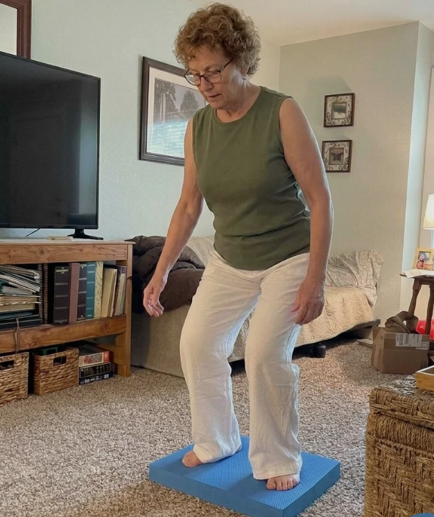 Older adult holding onto a kitchen counter